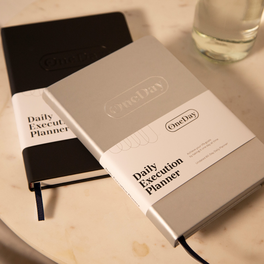 Goal Getter Gray Daily Execution Planner with faux leather cover and elastic closure, designed for goal-setting and productivity.
