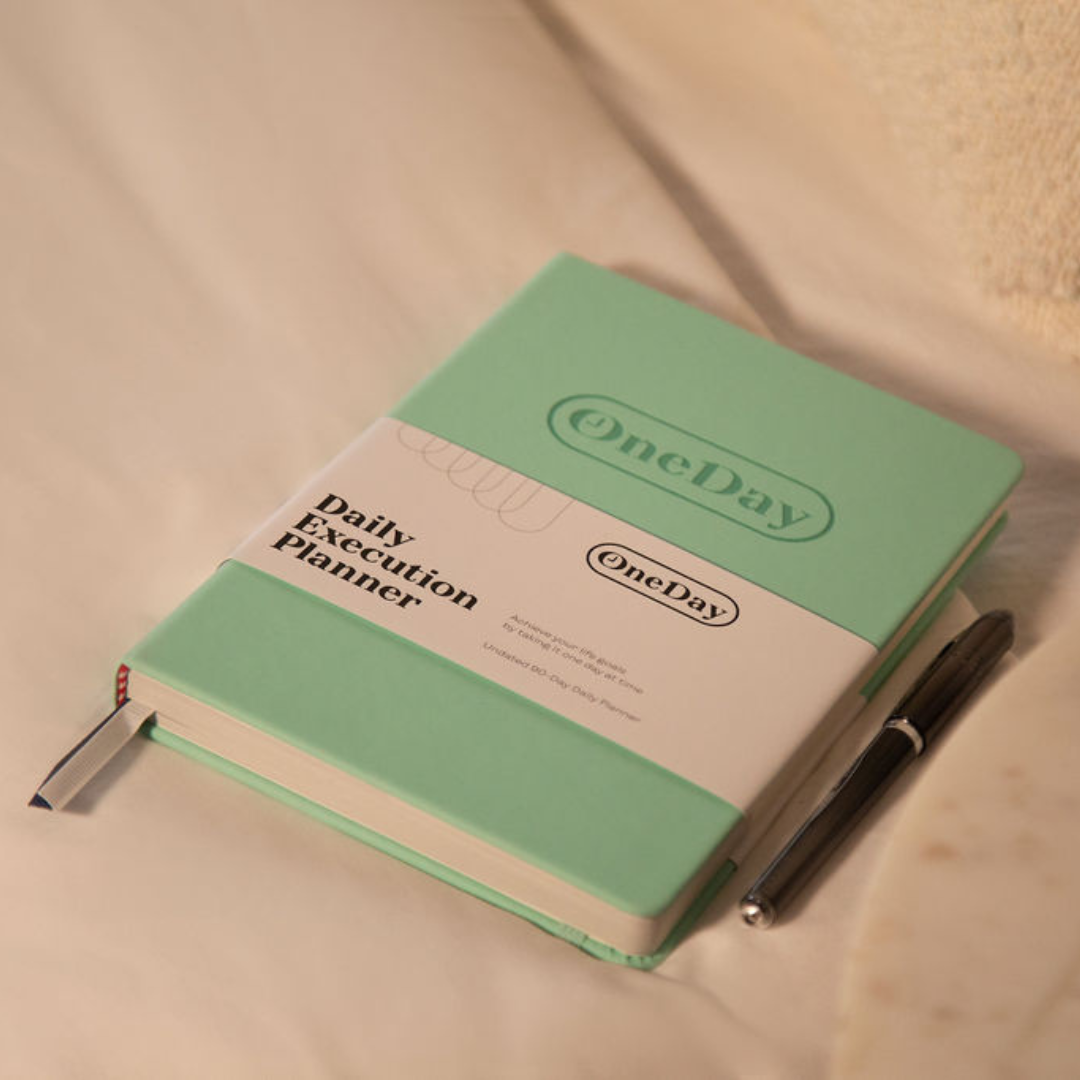 Tenacious Teal Daily Execution Planner on a desk, perfect for professional and personal productivity.