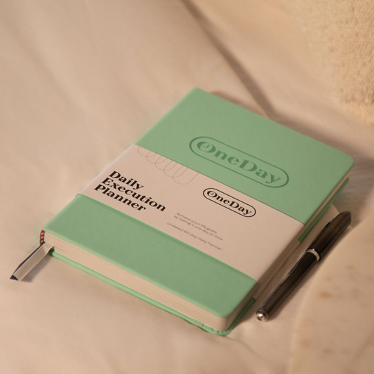 Tenacious Teal Daily Execution Planner on a desk, perfect for professional and personal productivity.